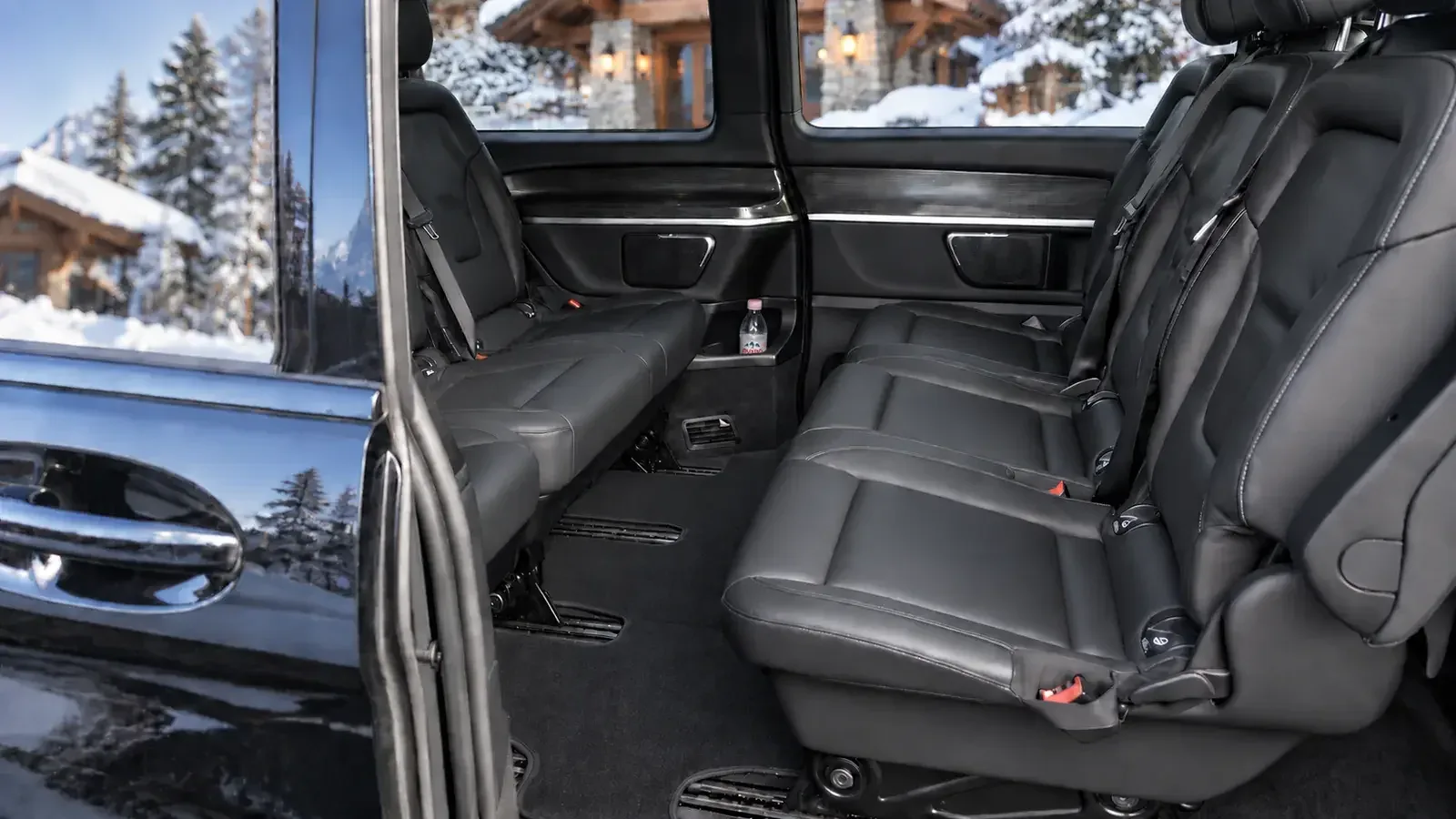 Black leather Mercedes-Benz V-Class passenger cabin prepared for a private Alpine transfer.