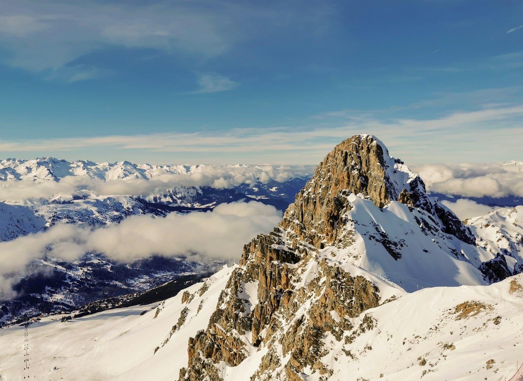 A high alpine peak above the clouds near Courchevel