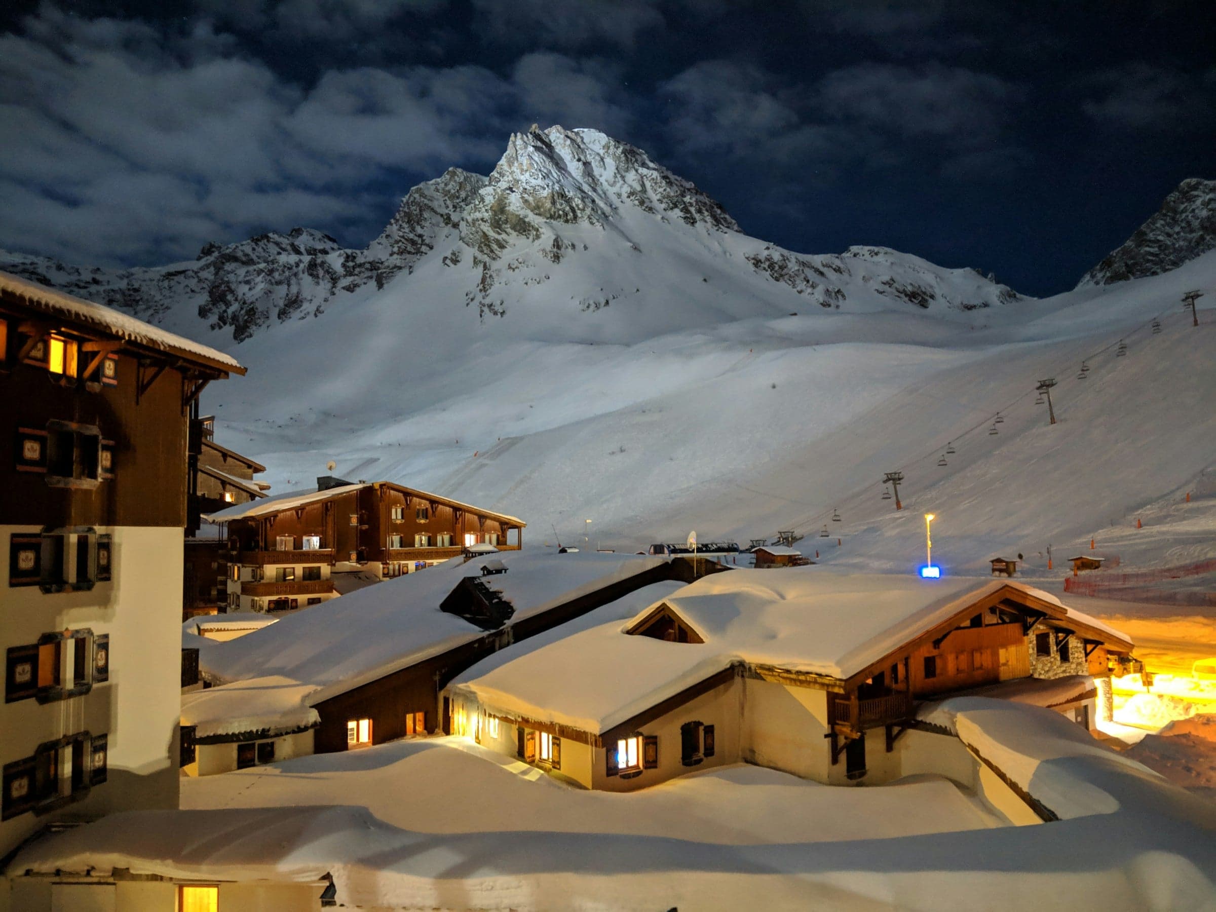 Snow-covered houses in Tignes at night