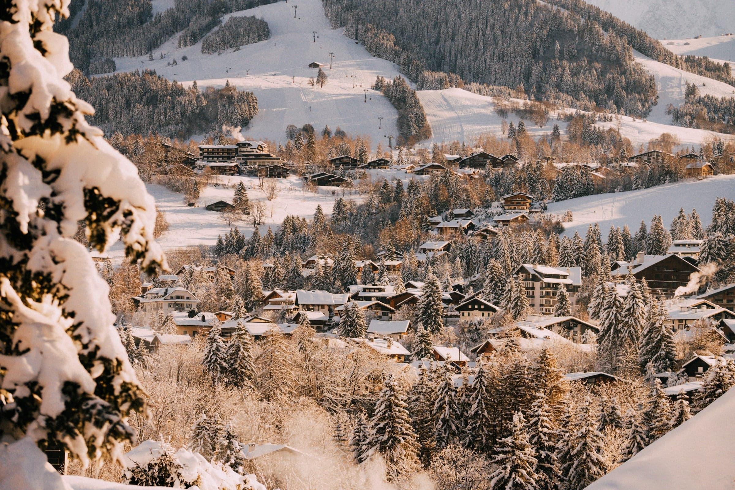 Snow-covered mountain with Megève village in the distance